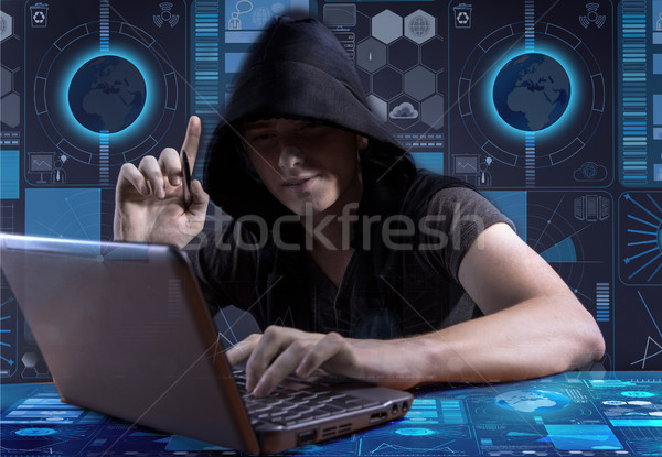 Stock photo: Young hacker in data security concept