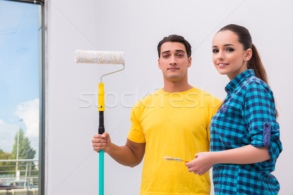 Young couple painting wall at home Stock photo © Elnur