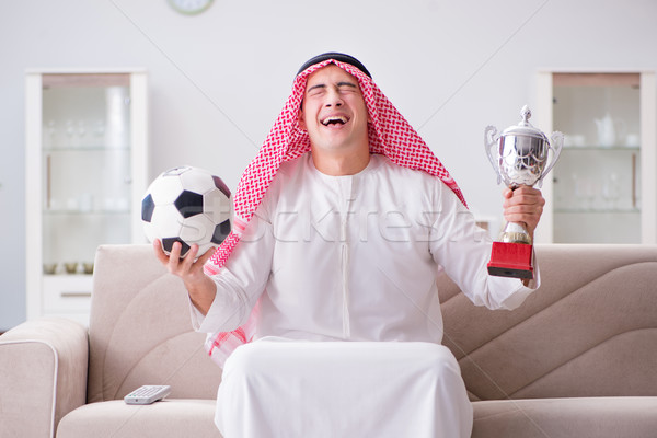Fiatal arab férfi néz futball ül Stock fotó © Elnur