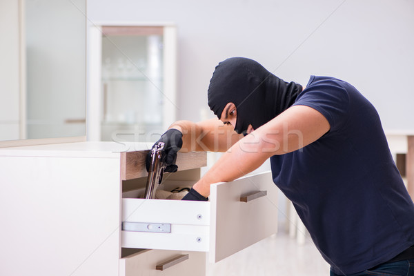 Robber wearing balaclava stealing valuable things Stock photo © Elnur