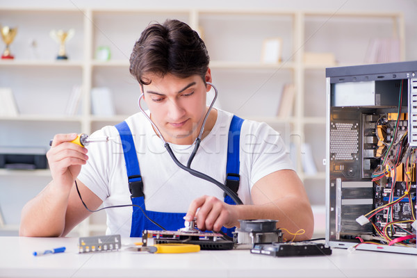 Computer repairman repairing desktop computer Stock photo © Elnur