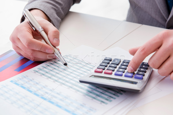 Finance analyst looking and financial reports Stock photo © Elnur