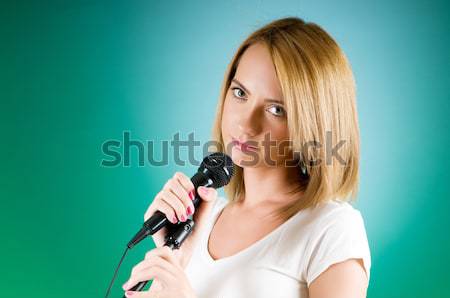 Stock photo: Woman singing in karaoke club