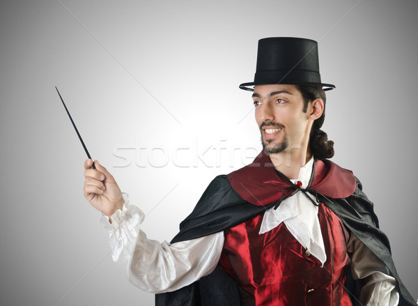 Magician doing tricks on white Stock photo © Elnur