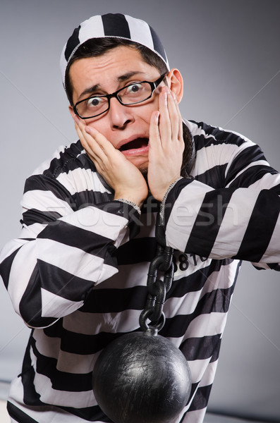 Funny prisoner in chains isolated on gray Stock photo © Elnur