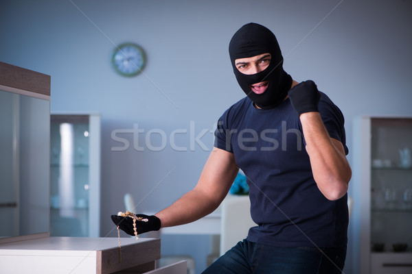 Stock photo: Robber wearing balaclava stealing valuable things