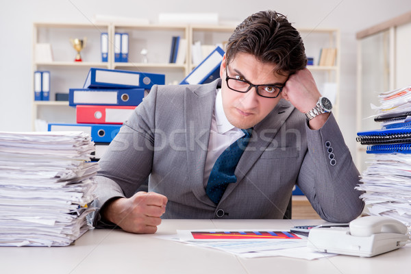 Businessman busy with much paperwork Stock photo © Elnur