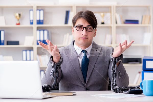 Businessman tied with chains to his work Stock photo © Elnur