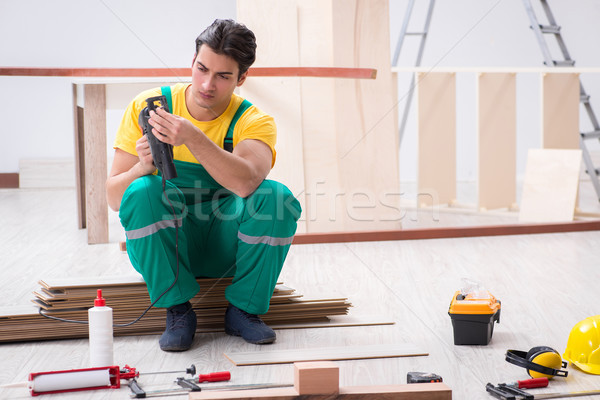 Contractor working on laminate wooden floor  Stock photo © Elnur