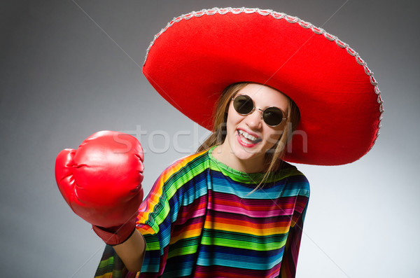 Girl in mexican vivid poncho and box gloves against gray Stock photo © Elnur