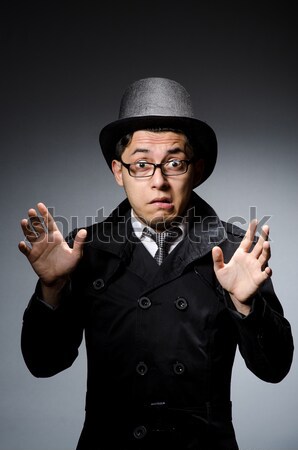 Fiatalember fekete kabát kalap szürke üzletember Stock fotó © Elnur