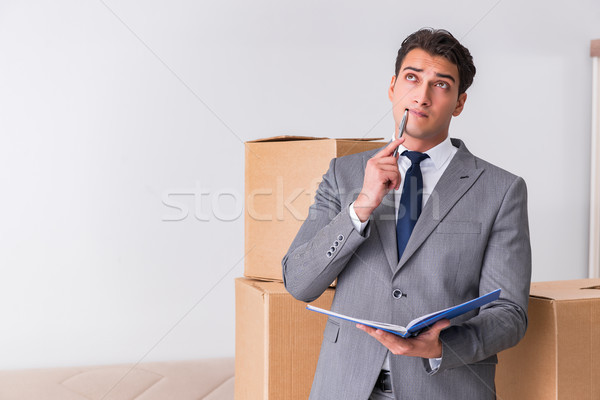Stock photo: Man signing for the delivery of boxes