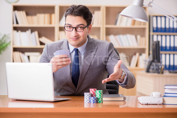 The businessman gambling playing cards at work Stock photo © Elnur