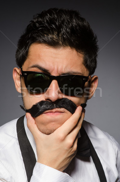 Młody człowiek fałszywy wąsy odizolowany szary moda Zdjęcia stock © Elnur