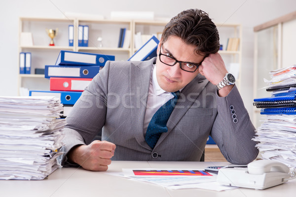 Businessman busy with much paperwork Stock photo © Elnur