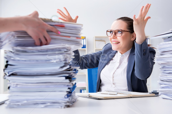 Tired businesswoman with paperwork workload Stock photo © Elnur
