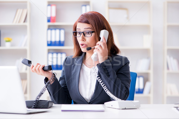 Frustrated call center assistant responding to calls Stock photo © Elnur