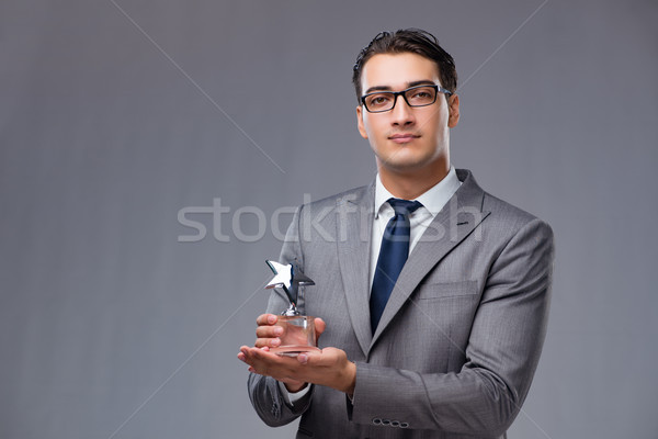 Stock photo: Businessman holding star award in business concept