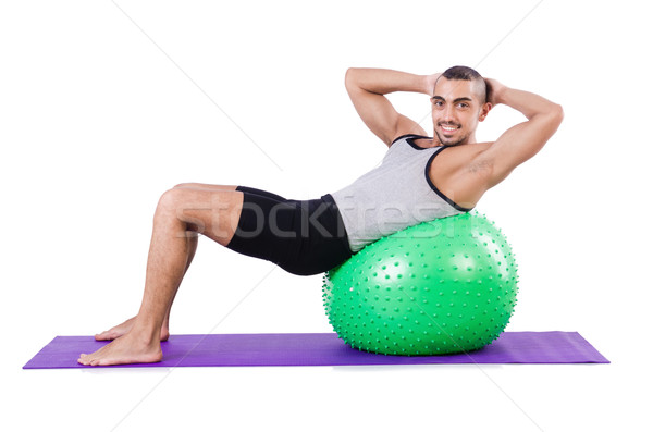 Man with swiss ball doing exercises on white Stock photo © Elnur