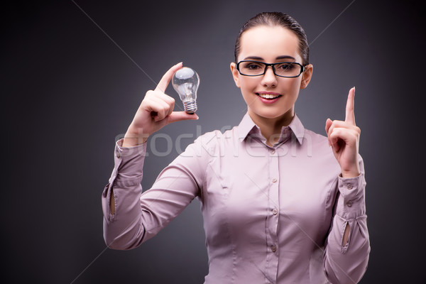 Stock photo: Young businesswoman in idea concept with light bulb