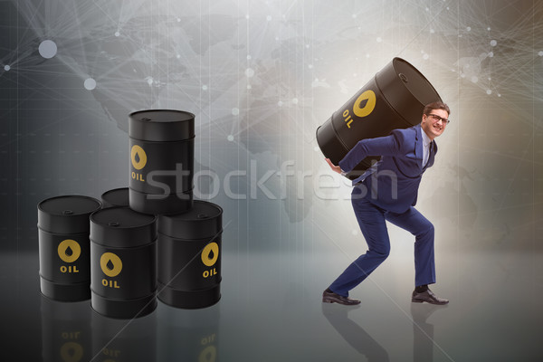 Businessman under the burden of oil barrel Stock photo © Elnur