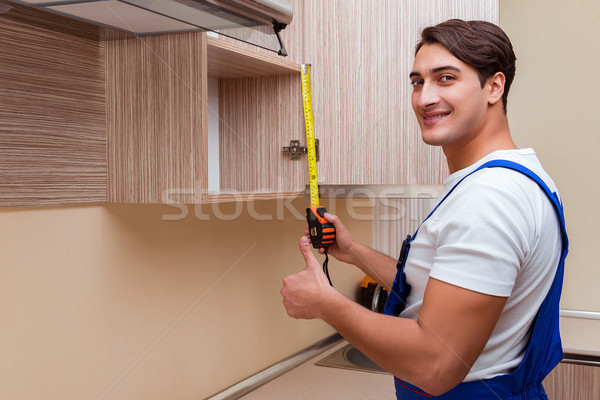 The young man assembling kitchen furniture Stock photo © Elnur