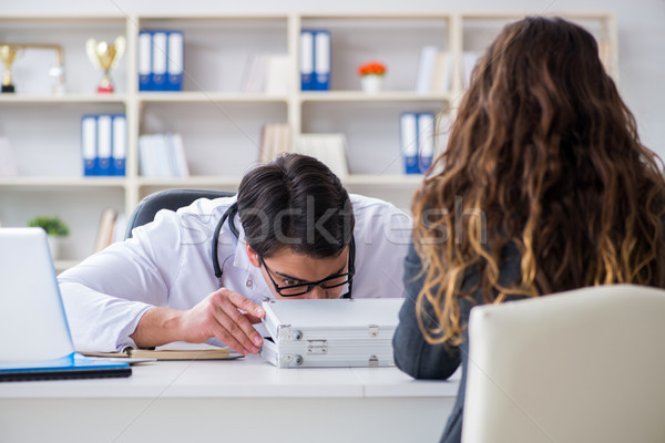 Young doctor in medical insurance fraud concept Stock photo © Elnur