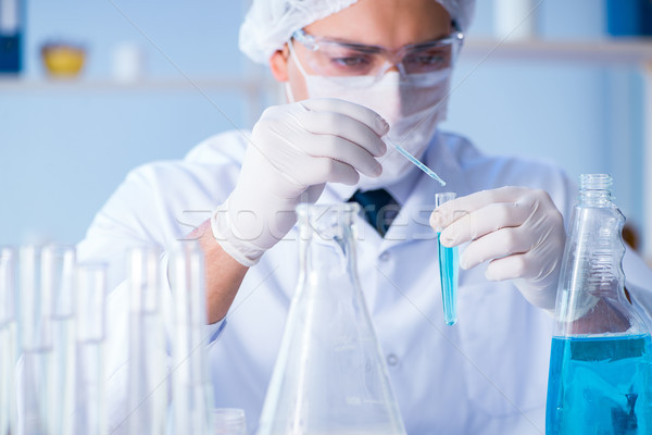 Female scientist researcher conducting an experiment in a labora Stock photo © Elnur