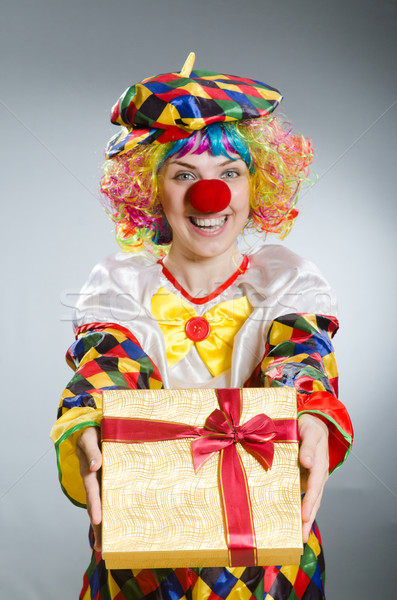 Stock photo: Clown with giftbox in funny concept