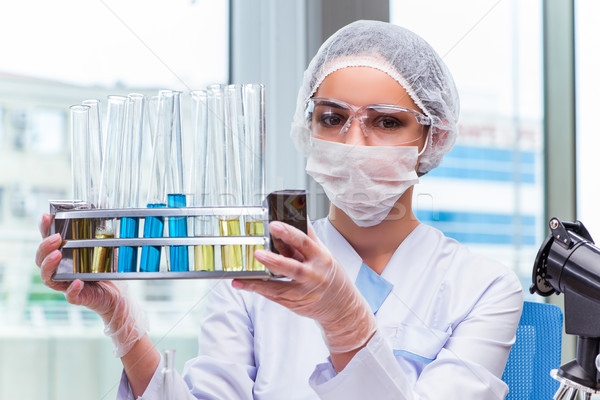 Stock photo: The young student working with chemical solutions in lab