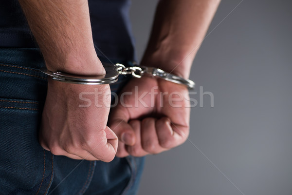 Man with his hands handcuffed in criminal concept Stock photo © Elnur