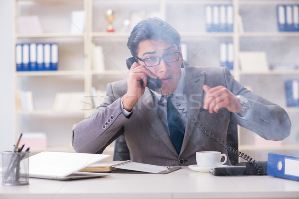 Businessman during fire alarm in office Stock photo © Elnur