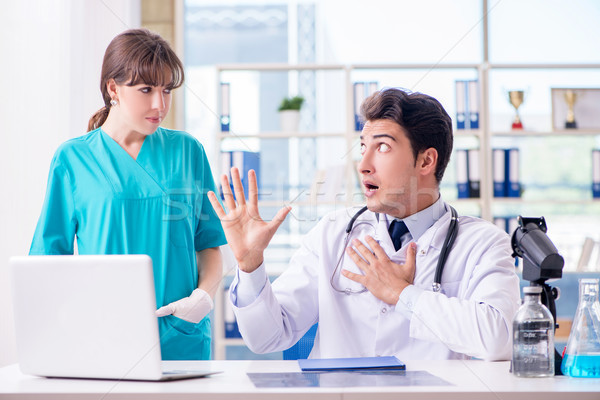 Doctor angry at his assistant due to medical error Stock photo © Elnur