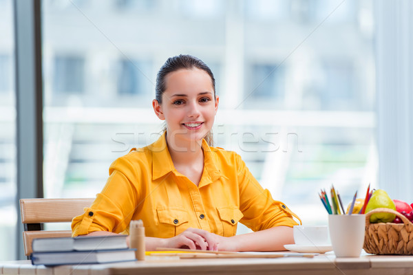 Young school gilr drawing pictures at home Stock photo © Elnur