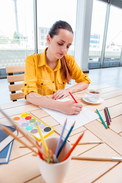 Young school gilr drawing pictures at home Stock photo © Elnur