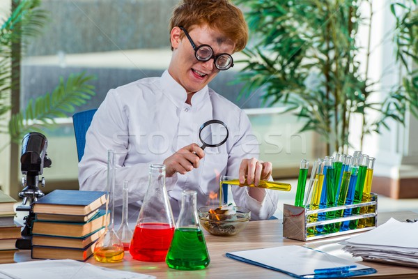 Young crazy chemist working in the lab Stock photo © Elnur