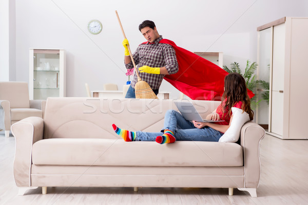 Superhero husband helping his wife at home Stock photo © Elnur