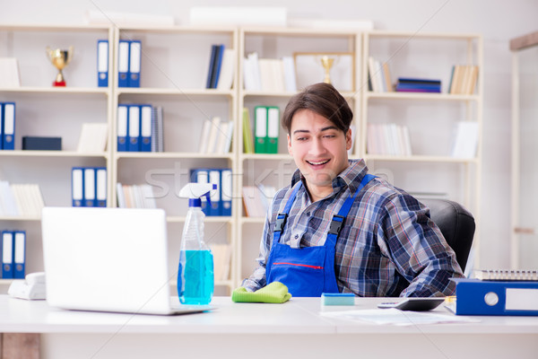 Male Worker Cleaning Sofa With Vacuum Cleaner Stock Photo