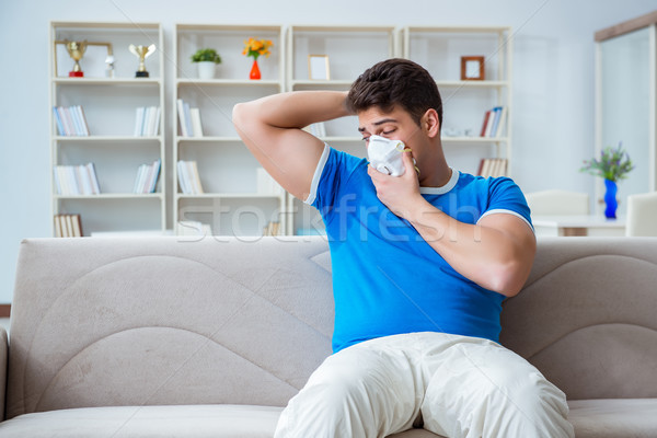 The man sweating excessively smelling bad at home Stock photo © Elnur