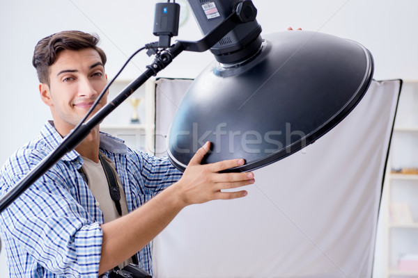 Young photographer working in photo studio Stock photo © Elnur