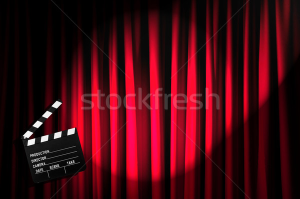Stock photo: Movie clapper board against curtain