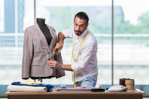 Young tailor working on new clothing design Stock photo © Elnur