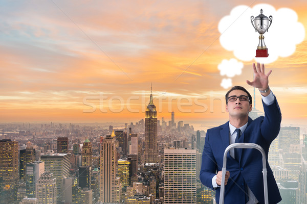 Businessman climbing towards his business goal Stock photo © Elnur