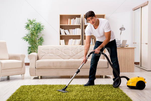 Man cleaning home with vacuum cleaner Stock photo © Elnur