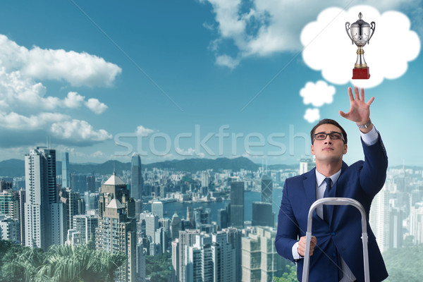 Businessman climbing towards his business goal Stock photo © Elnur