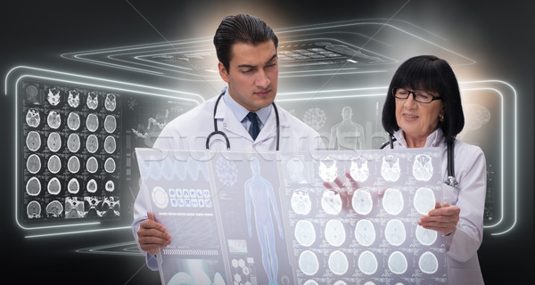 Woman and man doctor looking at MRI scan image Stock photo © Elnur