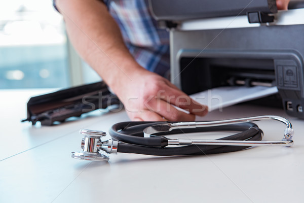 The repairman repairing broken color printer Stock photo © Elnur