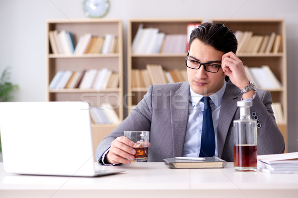 Young businessman drinking from stress Stock photo © Elnur