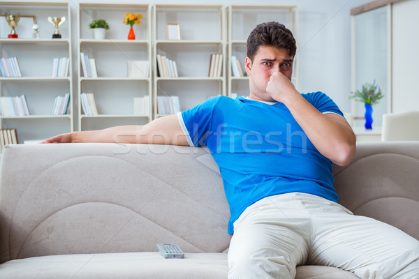 The man sweating excessively smelling bad at home Stock photo © Elnur