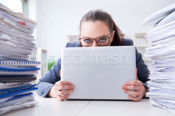 Tired businesswoman with paperwork workload Stock photo © Elnur